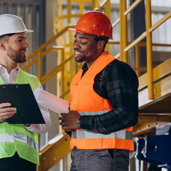 Inspector and african american worker in a factory